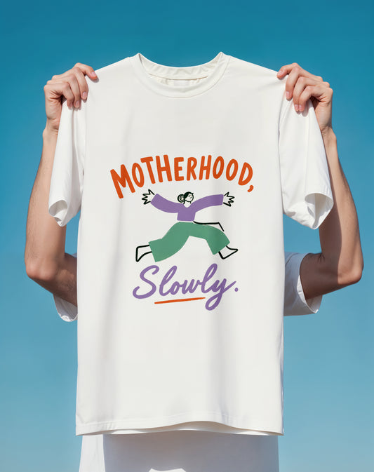 Motherhood Slowly Graphic T-Shirt  Funny Mom Shirt, Playful Illustration & Slogan